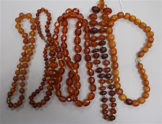 Five assorted amber necklaces.